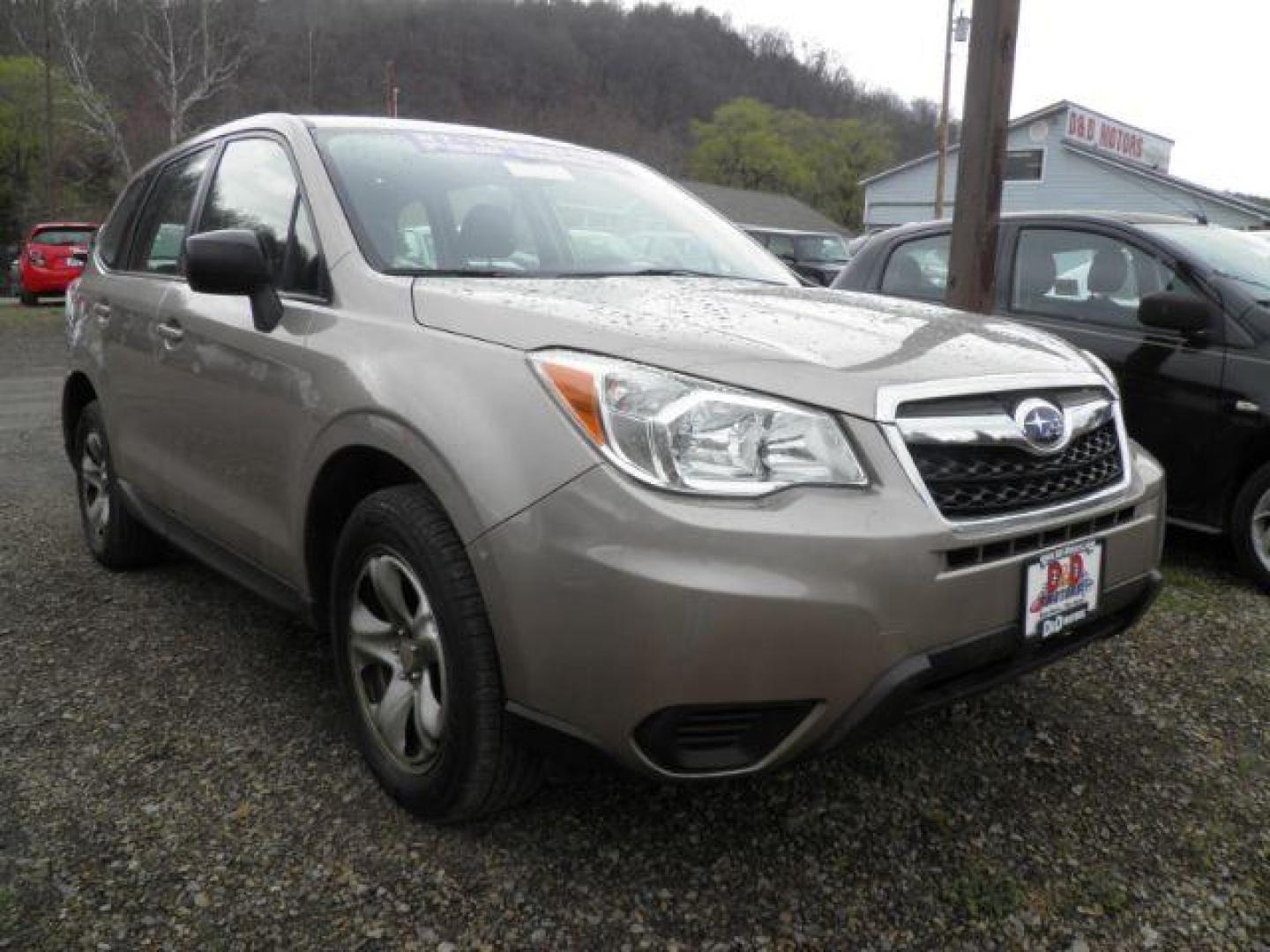 2015 GOLD Subaru Forester 2.5i (JF2SJAAC7FG) with an 2.5 L4 engine, 6SP transmission, located at 19521 New George's Creek Rd SW, Barton, MD, 21521, (301) 463-2404, 39.524323, -79.017906 - Photo#0